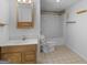 Cozy bathroom with wooden vanity, tile floor, and tub with shower at 445 Turner Dr, Mcdonough, GA 30252