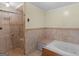 Bathroom featuring a combined shower and soaking tub with tiled walls and floors at 445 Turner Dr, Mcdonough, GA 30252