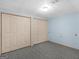 Carpeted bedroom features two closets with double doors and pale blue walls at 445 Turner Dr, Mcdonough, GA 30252