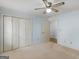 Bedroom featuring closet, ceiling fan, neutral carpet and door to another room at 445 Turner Dr, Mcdonough, GA 30252