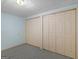 Carpeted bedroom features two closets with double doors and pale blue walls at 445 Turner Dr, Mcdonough, GA 30252