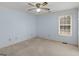 Light blue bedroom featuring a window, ceiling fan, and neutral carpeting at 445 Turner Dr, Mcdonough, GA 30252