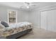 Bedroom featuring a ceiling fan, neutral carpet, closet and light-filled window at 445 Turner Dr, Mcdonough, GA 30252