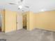 This is a bedroom with neutral carpet, yellow walls, and a ceiling fan at 445 Turner Dr, Mcdonough, GA 30252