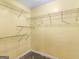 Bright, empty closet with yellow walls and wire shelving is ready to be organized at 445 Turner Dr, Mcdonough, GA 30252