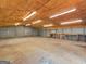 Interior view of a large garage, featuring ample lighting, insulated ceiling, and workbench area at 445 Turner Dr, Mcdonough, GA 30252