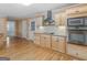 Well-lit kitchen featuring custom cabinetry, stainless steel appliances, granite countertops, and hardwood flooring at 445 Turner Dr, Mcdonough, GA 30252