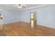 Bright living room features hardwood floors, a ceiling fan, and neutral paint at 445 Turner Dr, Mcdonough, GA 30252