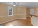 Sunlit living area featuring hardwood floors, neutral paint, and a large window with backyard view at 445 Turner Dr, Mcdonough, GA 30252