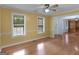 Spacious living room featuring hardwood floors, neutral walls, and a ceiling fan at 445 Turner Dr, Mcdonough, GA 30252