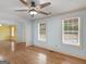 Bright living room with hardwood floors, two windows and a ceiling fan at 445 Turner Dr, Mcdonough, GA 30252