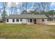 Rear exterior view of the home with a covered patio area and manicured lawn at 225 Highway 212 S, Covington, GA 30014