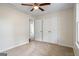 Bedroom featuring a ceiling fan, neutral carpet, and a closet at 225 Highway 212 S, Covington, GA 30014