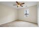 Neutral bedroom featuring a ceiling fan, carpet, and a window view at 225 Highway 212 S, Covington, GA 30014