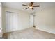 Spacious bedroom with neutral carpet, ceiling fan, and double door closet at 225 Highway 212 S, Covington, GA 30014