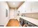 Well-lit laundry room with white cabinetry, counter space, and modern washer/dryer at 0 Ebenezer Rd # 9, Fayetteville, GA 30215