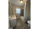 Well-lit bathroom featuring a bathtub with shower, vanity and new flooring at 1573 Carroll Nw Dr, Atlanta, GA 30318