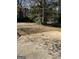 View of backyard with a concrete patio area and mature trees at 1125 Carlo Sw Ct, Atlanta, GA 30331