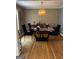 This modern dining room features an ornate hanging light fixture and wood floors at 1125 Carlo Sw Ct, Atlanta, GA 30331