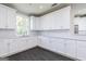 This bright kitchen showcases white cabinets, subway tile backsplash, modern fixtures, and generous counter space at 1033 Claas Way, Locust Grove, GA 30248