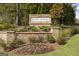 Community entrance sign 'Bunn Farms' surrounded by lush landscaping and decorative stone pillars at 1033 Claas Way, Locust Grove, GA 30248