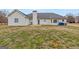 Exterior view of the backyard featuring a covered patio and spacious lawn at 234 Thorne Wood Ln, Hampton, GA 30228