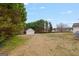 Sprawling backyard with a detached garage/shed surrounded by mature trees at 234 Thorne Wood Ln, Hampton, GA 30228