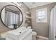 Chic bathroom with a modern sink, decorative shelves, and a window offering natural light at 234 Thorne Wood Lane, Hampton, GA 30228