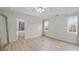 Bright bedroom with two windows, tray ceiling, and an ensuite bathroom at 234 Thorne Wood Ln, Hampton, GA 30228