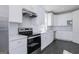 Modern kitchen featuring white cabinets, stainless steel appliances, and subway tile backsplash at 1029 Claas Way, Locust Grove, GA 30248