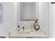 Close-up on white bathroom vanity, featuring a modern mirror, elegant faucet, and stylish decor at 567 Middle Sw St, Atlanta, GA 30310