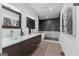 An elegant bathroom features a double vanity with glass sinks, a modern tub, and a shower at 567 Middle Sw St, Atlanta, GA 30310