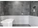 A modern soaking tub is shown against tile accents in the bathroom at 567 Middle Sw St, Atlanta, GA 30310