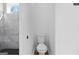 Elegant bathroom featuring a toilet, a stylish shower with gray tiles and black honeycomb flooring at 567 Middle Sw St, Atlanta, GA 30310