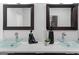 A bathroom vanity showcases glass sinks and modern faucets set against framed mirrors at 567 Middle Sw St, Atlanta, GA 30310