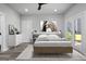 Bedroom with modern furnishings, including a platform bed, dresser, and french doors to the backyard at 567 Middle Sw St, Atlanta, GA 30310