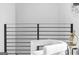 Hallway with a modern railing and white chair, leading to more of the home at 567 Middle Sw St, Atlanta, GA 30310