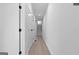 Long hallway with white walls and doors leading to stairs, creating a bright and open feel at 567 Middle Sw St, Atlanta, GA 30310