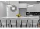 Kitchen island with bar stools and modern lighting above, with sleek white cabinetry at 567 Middle Sw St, Atlanta, GA 30310