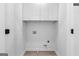 A practical laundry room features white cabinets, washer and dryer hookups, and modern flooring at 567 Middle Sw St, Atlanta, GA 30310
