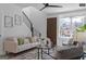 Living room with modern decor, including contemporary furniture, abstract art, and a ceiling fan at 567 Middle Sw St, Atlanta, GA 30310