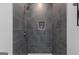 Modern shower featuring gray tiled walls, a built-in niche, and stylish fixtures at 567 Middle Sw St, Atlanta, GA 30310