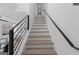 Contemporary staircase with wooden steps, black metal railings and a white wall at 567 Middle Sw St, Atlanta, GA 30310