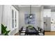 Modern dining room featuring sleek table and chairs with artwork, chandelier and natural light at 0 Lot 2 Mcbride Rd, Fayetteville, GA 30215