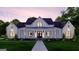 Inviting two-story modern farmhouse with charming front porch and large manicured lawn at 0 Lot 2 Mcbride Rd, Fayetteville, GA 30215