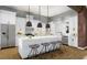 Open kitchen with white cabinets, stainless steel appliances, an island with stool seating, and pendant lighting at 0 Lot 2 Mcbride Rd, Fayetteville, GA 30215