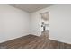 Bright living area displaying wood-look flooring and neutral walls, leading into the kitchen at 1013 Claas Way, Locust Grove, GA 30248