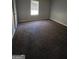 Bedroom with neutral walls, plush carpet, and a bright window at 263 Rocky Point Rd, Covington, GA 30014