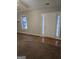 Open living room with neutral paint, ceiling fan and light filled entry at 263 Rocky Point Rd, Covington, GA 30014