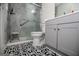 Modern bathroom with a tiled walk-in shower and black and white patterned flooring at 3266 Greenhill Ct, Villa Rica, GA 30180